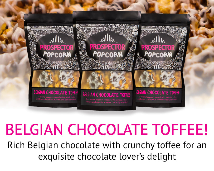 Three packages of Prospector Popcorn with Belgian Chocolate Toffee flavor are displayed against a blurred background of popcorn. The text reads, "BELGIAN CHOCOLATE TOFFEE! Rich Belgian chocolate with crunchy toffee for an exquisite chocolate loverโs delight.