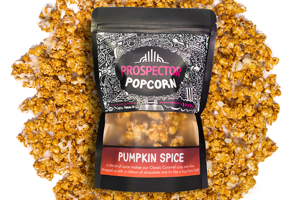 A Prospector Popcorn Pumpkin Spice place on top of pumpkin spice gourmet popcorn