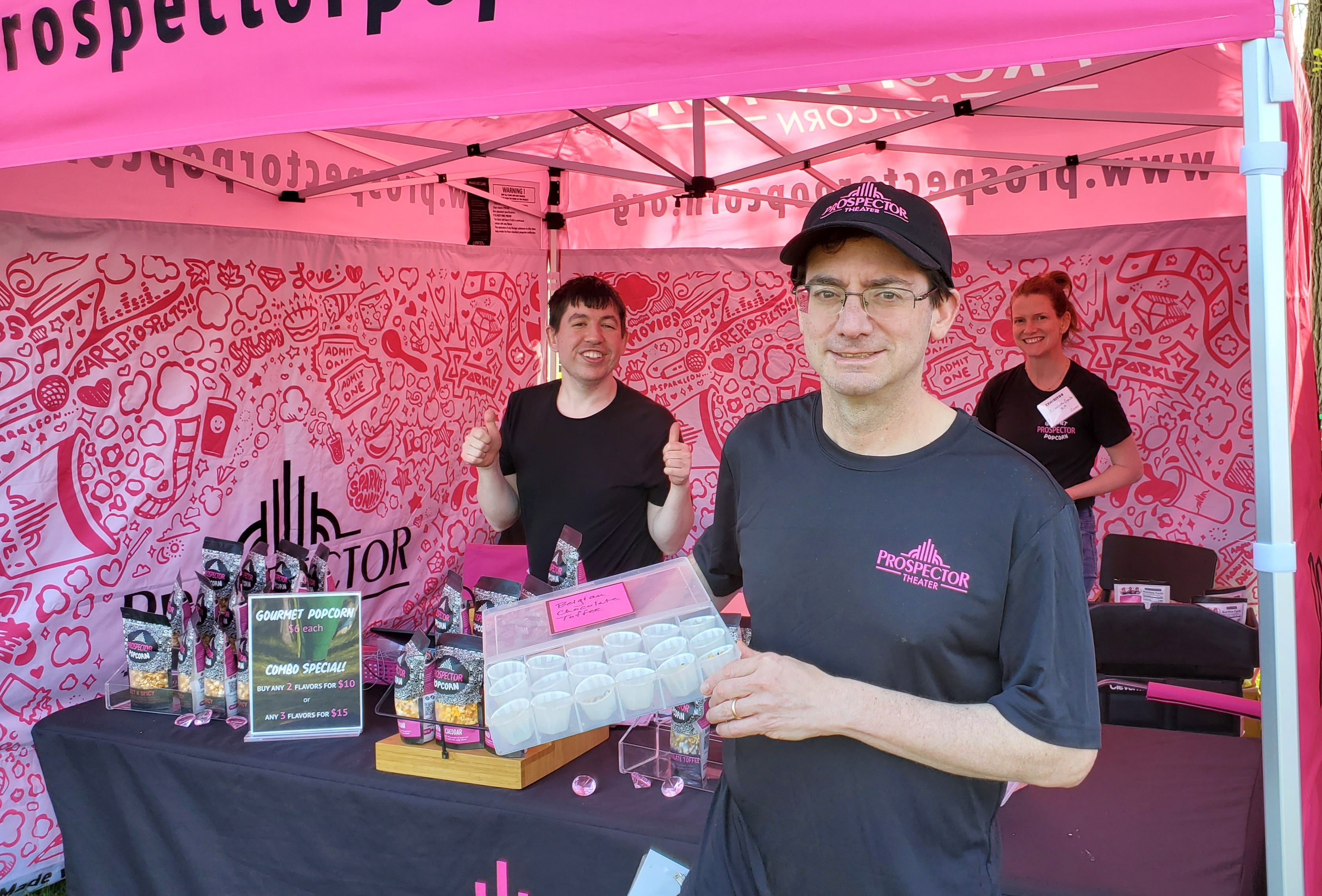 Prospect hold popcorn samples at pink tent famers market