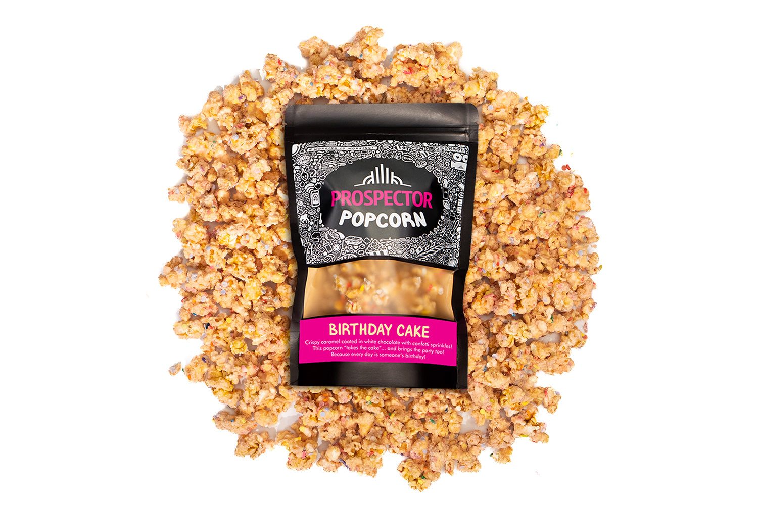 A bag of Birthday Cake Gourmet Popcorn lays on a pile of its popcorn that has sprinkles throughout.