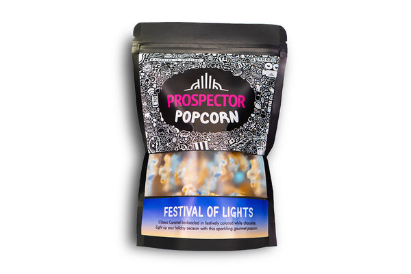 A bag of Festival of Lights gourmet Prospector Popcorn sits on a white background