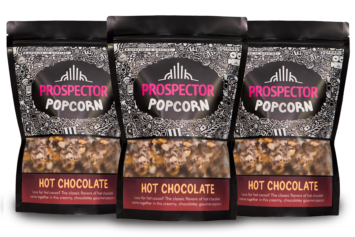 Three bags of Prospector Popcorn, labeled "Hot Chocolate" flavor, are lined up. The packaging features intricate black and white patterns with a clear window showing the popcorn inside. Each bag includes text about the hot chocolate flavor.