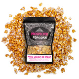 A bag of Maple Walnut Ice Cream popcorn lays on a pile of its popcorn.