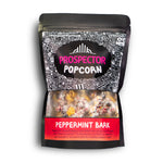 A bag of Peppermint Bark gourmet Prospector Popcorn sits on a white background.