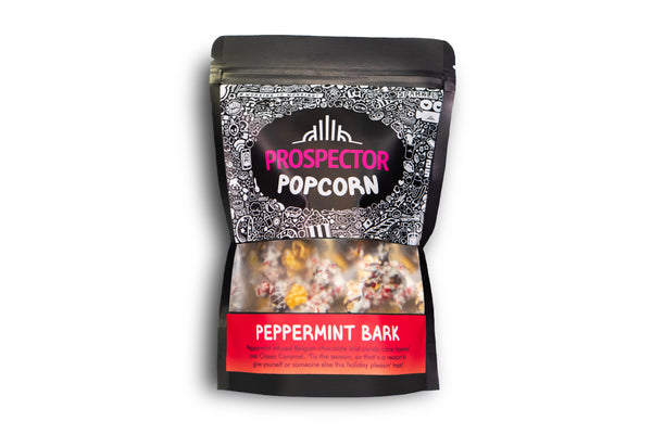 A bag of Peppermint Bark gourmet Prospector Popcorn sits on a white background.