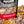 Load image into Gallery viewer, A bag of Peppermint Bark gourmet Prospector Popcorn stands in a pile of its own popcorn.
