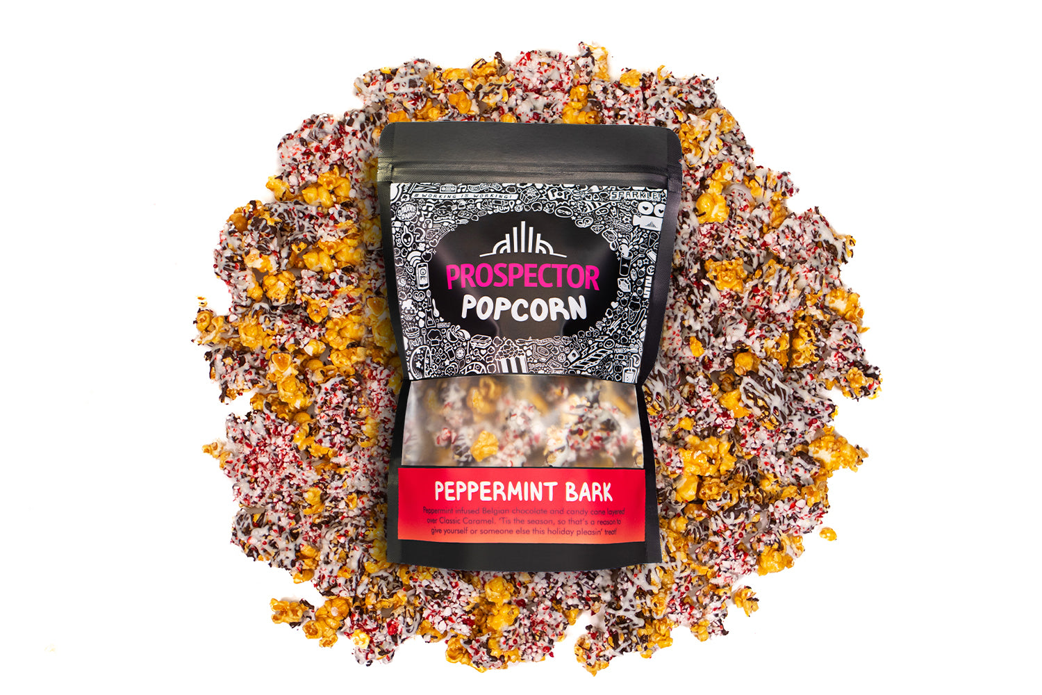 A bag of Peppermint Bark gourmet Prospector Popcorn lays on a pile of its own popcorn.