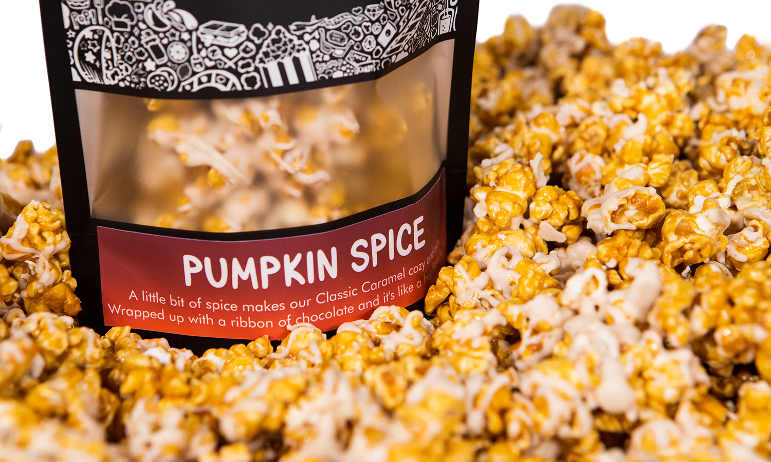 A bag of Pumpkin Spice gourmet popcorn sits in a pile of its own popcorn