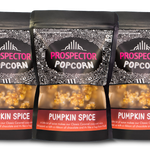 Three bags of Prospector Popcorn Pumpkin Spice flavor on a white background