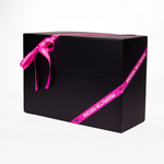 A large black gift box wrapped with a purple ribbon that has the words "Prospector Popcorn" printed on it. The box is set against a plain white background.