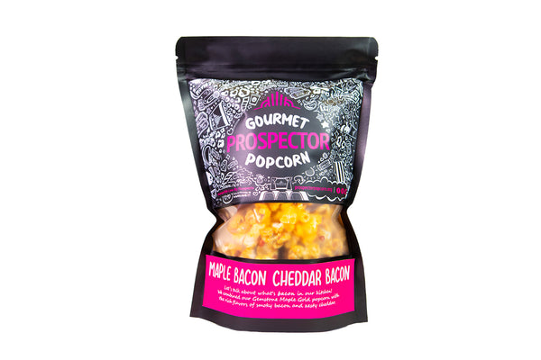 A bag of Maple Bacon Cheddar Bacon Gourmet Popcorn sits on a white background
